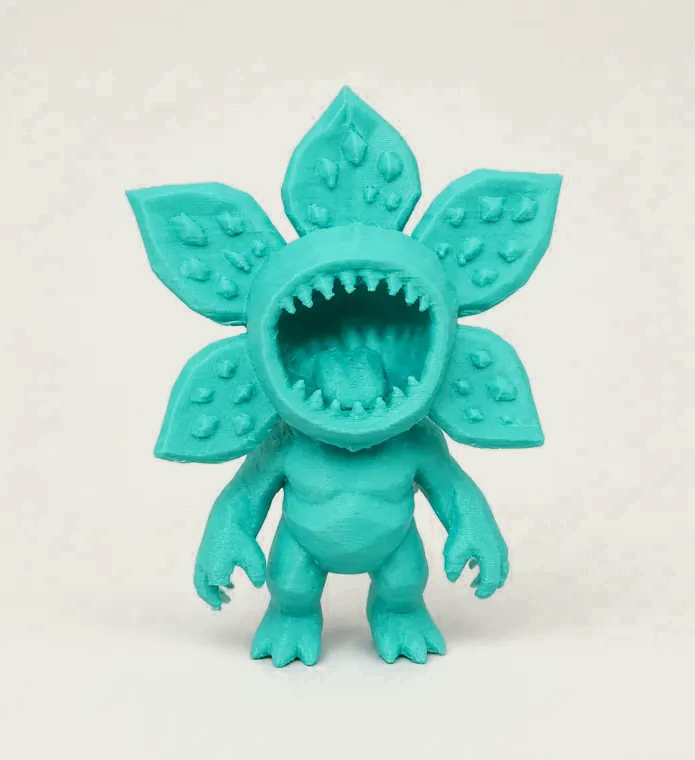 Teal winged creature figure